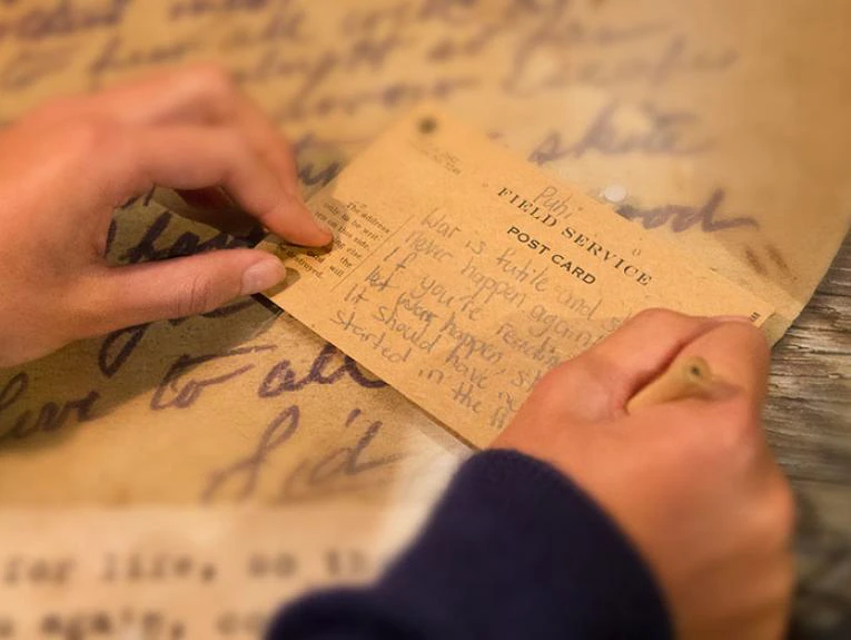 Child writing a note about war in the Gallipoli exhibition