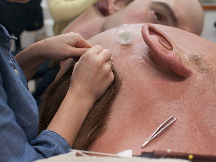 Adding hair, 2015. Photograph by Weta Workshops Individual hairs are added to the head of a giant