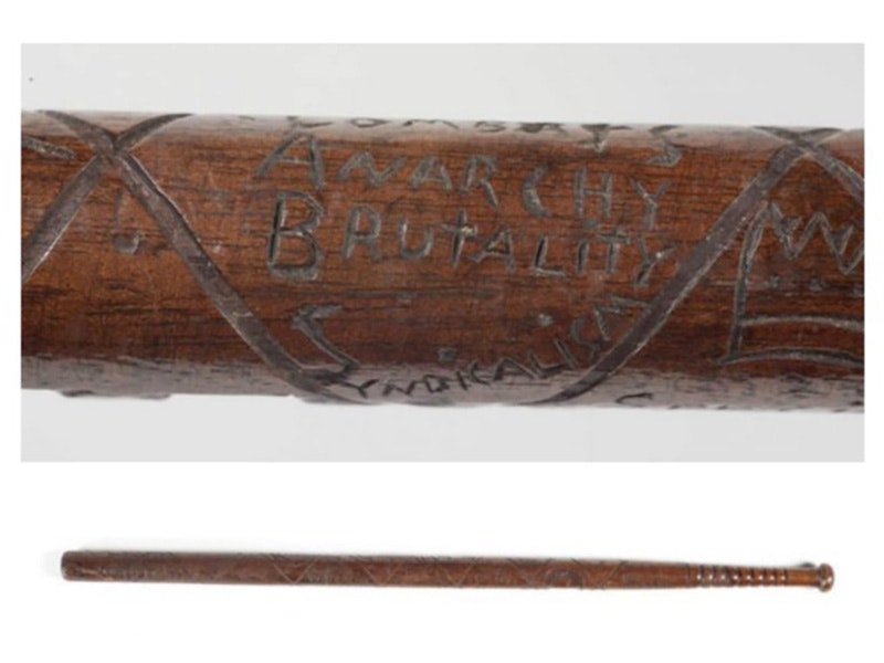 Special Constable’s Baton, 1913, maker unknown, Hugh White. Gift of Mr Hugh White, 2005. CC BY-NC-ND licence. Te Papa (GH011601) A closeup photo of inscription on a wooden baton, saying 'Combats anarchy, brutality, socialism'. The full baton is shown below.