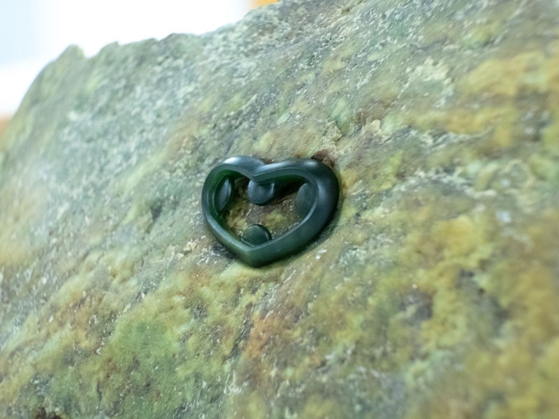 Tohu Reo pounamu pin, 2018. Te Papa A greenstone carved into an abstract heart shape