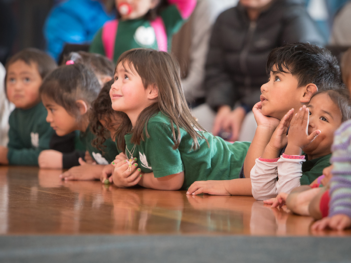 Child listening to a story on the marae during Matariki