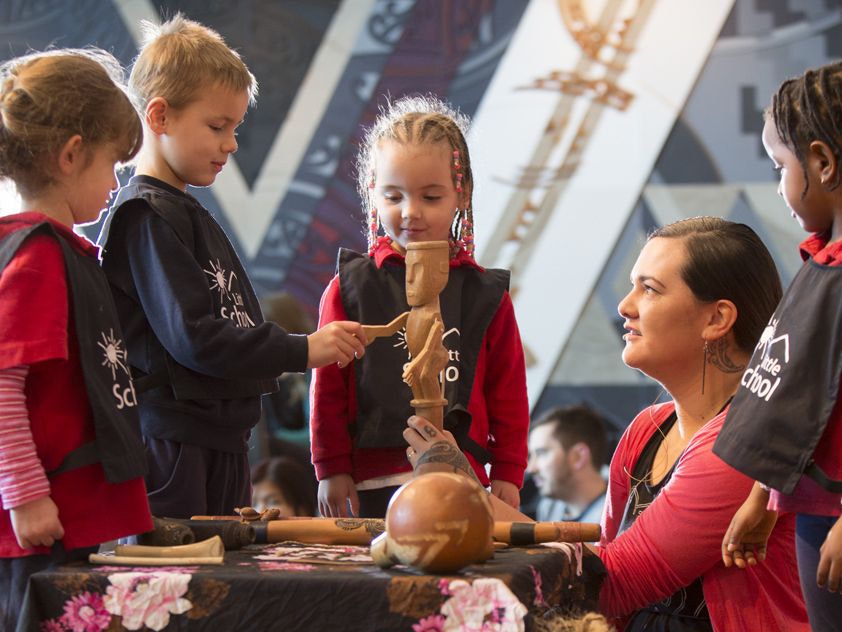 Children greeting the karetao (traditional Māori puppet). 2015. Photograph by Kate Whitley. Te Papa Children participating in workshop