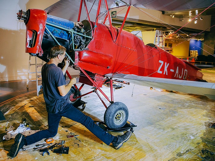 Dismantling of the Tiger Moth begins, 2017. Te Papa Tiger Moth plane is dismantled on the museum floor
