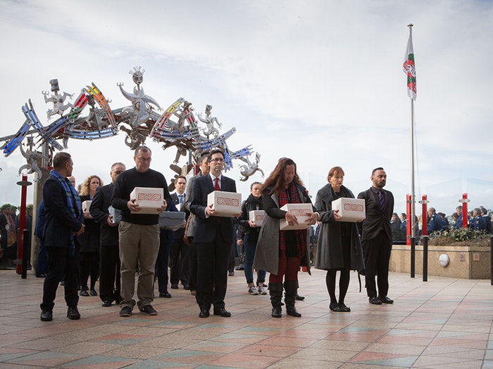 Arriving at Te Papa with the Māori and Moriori skeletal remains, 2016. Photograph by Kate Whitley. Te Papa A group of people hold boxes containing Māori and Moriori skeletal remains