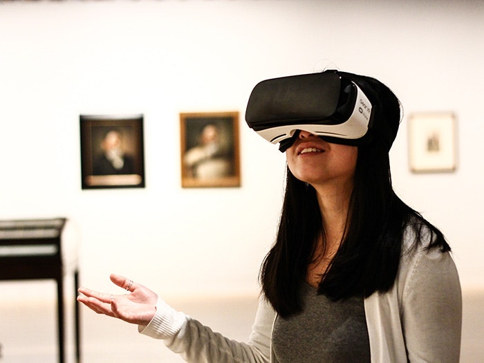 Using VR, 2016. Photograph by Felicity Powell. Te Papa A woman wears a VR headset in an art gallery