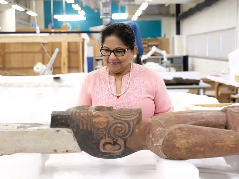 Conservator Nirmala Balram with Rongotueruora (also known as Iron Man) in Te Papa’s conservation lab, 2017. Photo by Rachael Hockridge. Te Papa Nirmala with Iron Man
