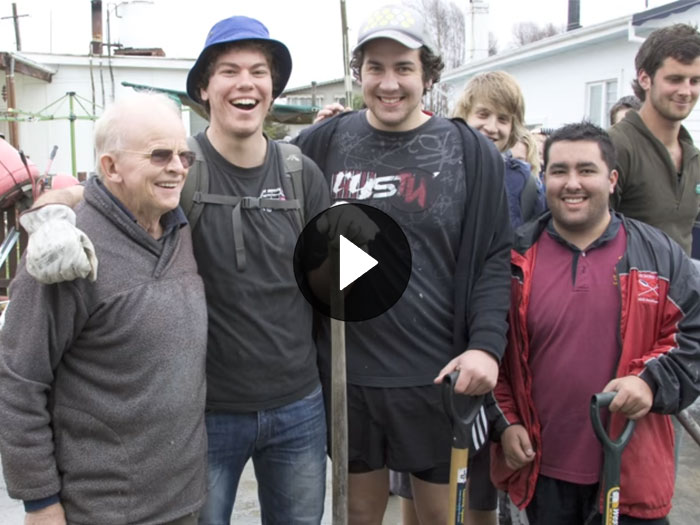 Student volunteers smile with other members on the public