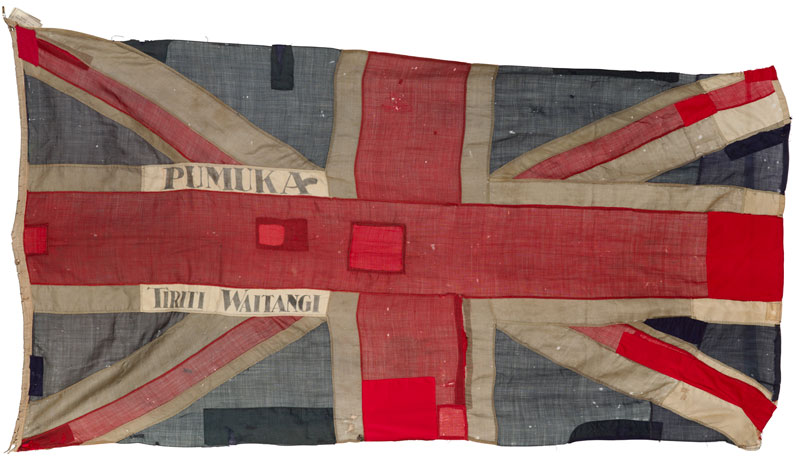 A Union Jack flag with the words Pumuka and Tiriti Waitangi embroidered on