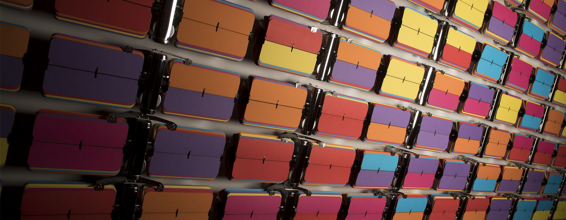 Close up of a wall of flip-clocks of many different colours