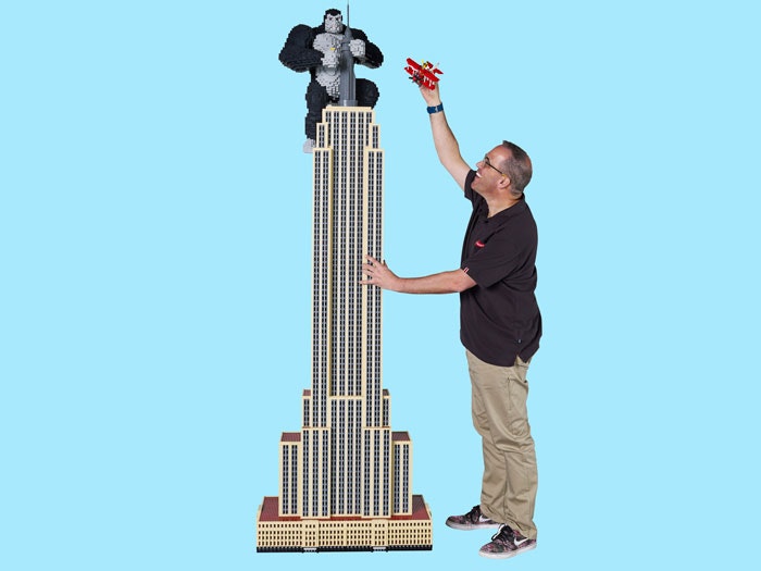 Ryan with LEGO model of the Empire State Building. Caption: Ryan McNaught (aka Brickman) with the LEGO® Empire State Building and King Kong Man with giant LEGO model of the Empire State Building