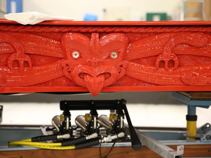 Michael Parekowhai, He Korero Purakau mo Te Awanui o Te Motu: story of a New Zealand river (2011) being prepared for transport, 2018. Photo by Jack Fisher. Te Papa Close-up of carving on a red piano with Māori design