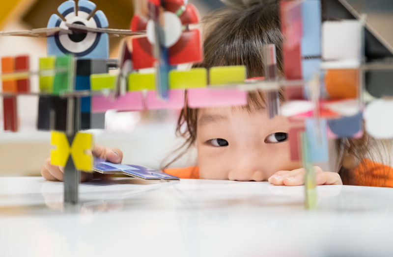 Child playing with colourful blocks