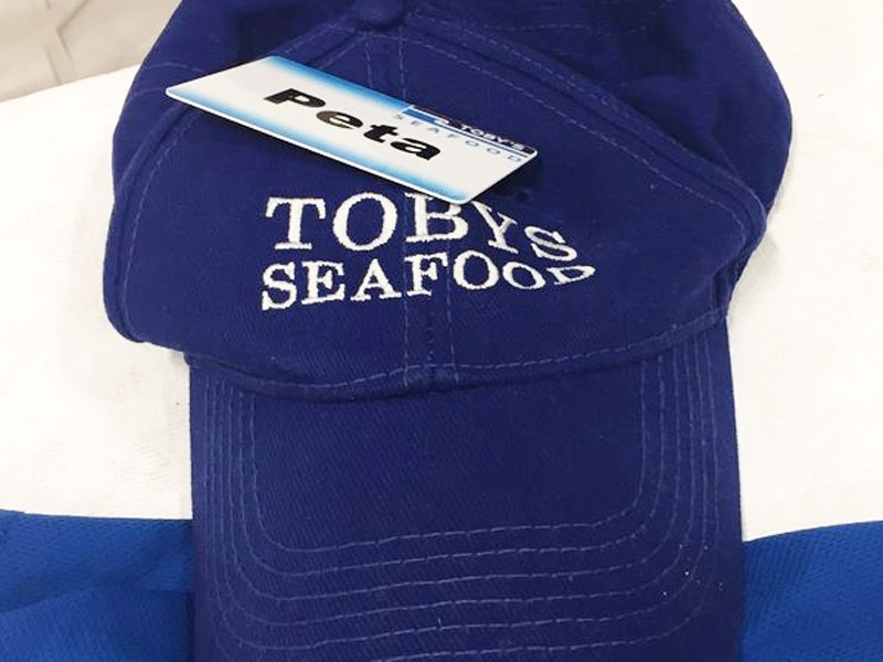 Elisapeta Fononga's cap, 2017. Photo by Noelle McCarthy Blue cap with the words 'Toby's Seafood' stitched in white