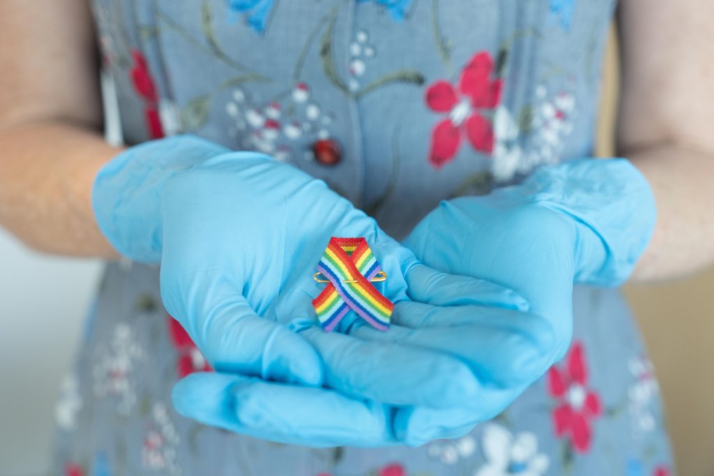 Stephanie Gibson holds a rainbow ribbon from this year’s Pride Festival