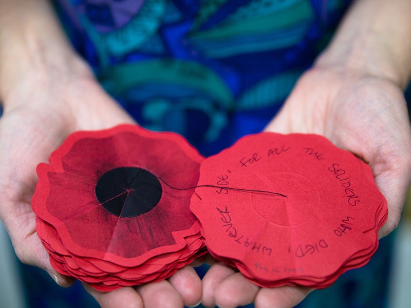 A poppy left by a visitor to Gallipoli: The scale of our war which reads: “For all the soldiers who died, whatever side.” Photo by Jack Fisher. Te Papa
