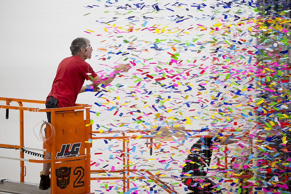 An man stands on a scissor lift installing Finale: Bouquet