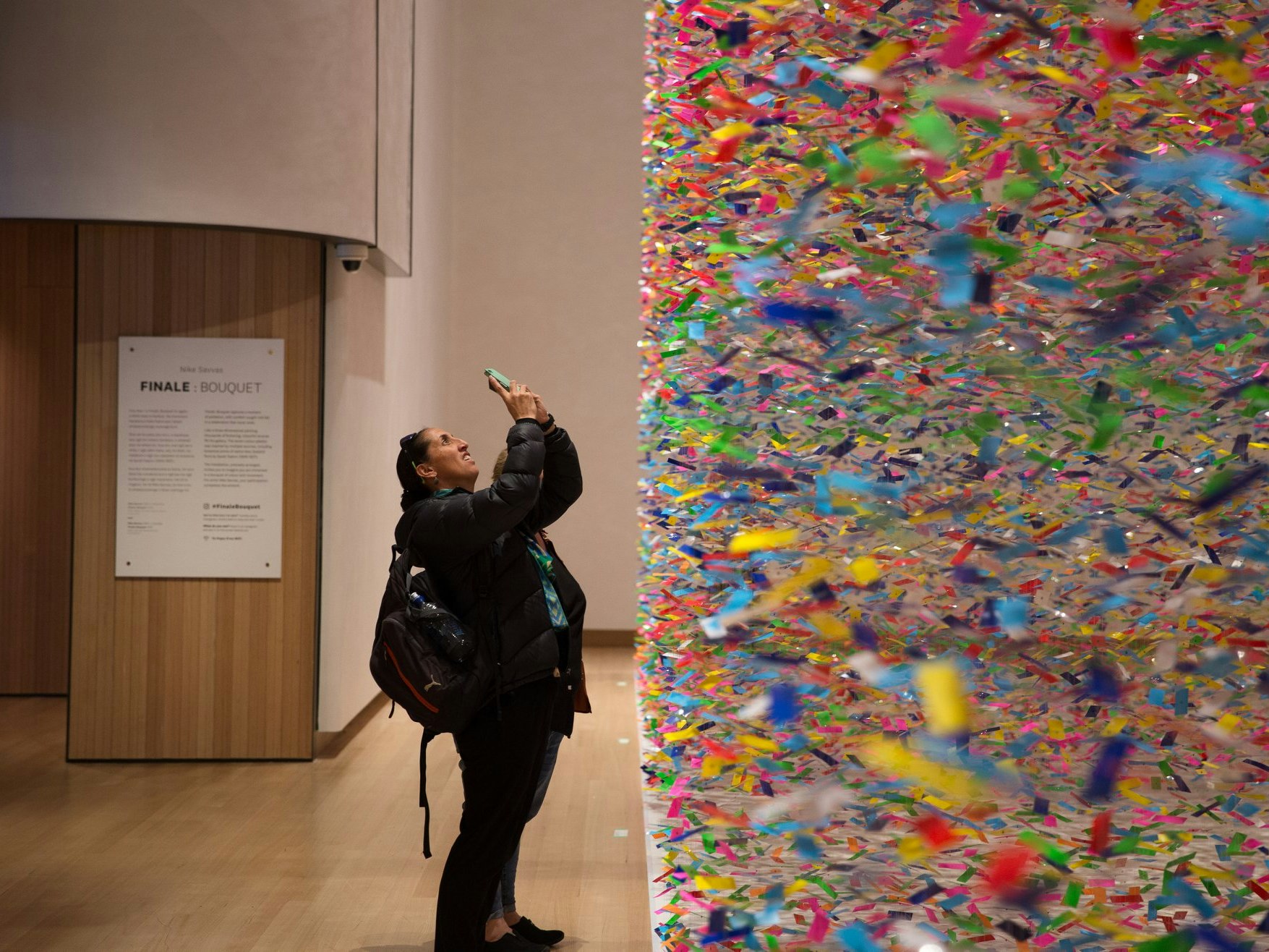 A visitor trying to capture the scale of Finale: Bouquet, 2019. Photo by Jack Fisher. Te Papa A visitor trying to capture the scale of a colourful artwork