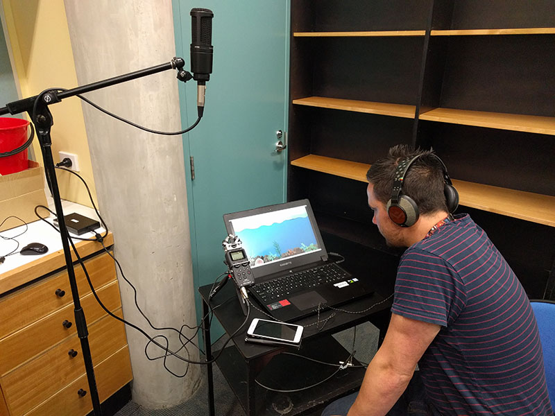 Martin sits at a laptop computer watching the footage that was recorded