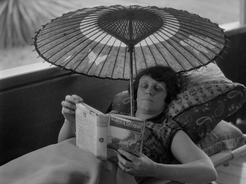 Woodside and Excursions from Woodside, 1928-1929, by Leslie Adkin. Te Papa (B.023342) A lady reads inside under a parasol