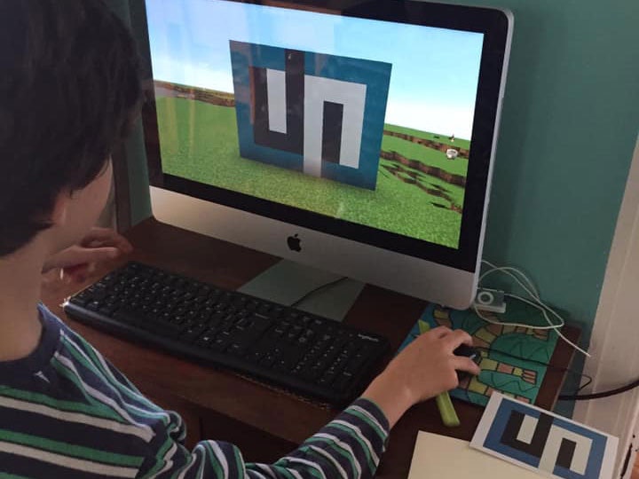 Copying a Gordon Walters artwork in 3D in Minecraft, 2020. Courtesy of Aman, age 10 A little boy copies an artwork in a Minecraft game