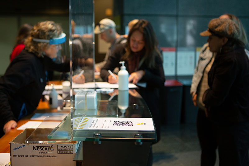 A woman signs into Te Papa