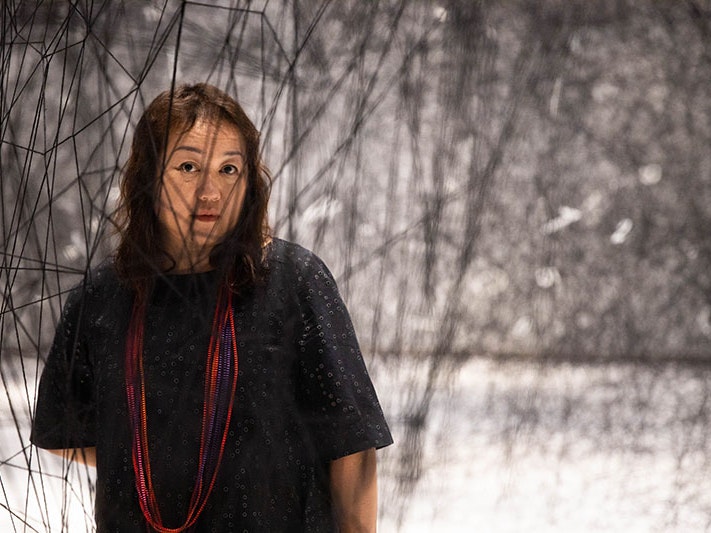 Chiharu Shiota, 2021. Photo by Jack Fisher. Te Papa Chiharu Shiota standing among The web of time