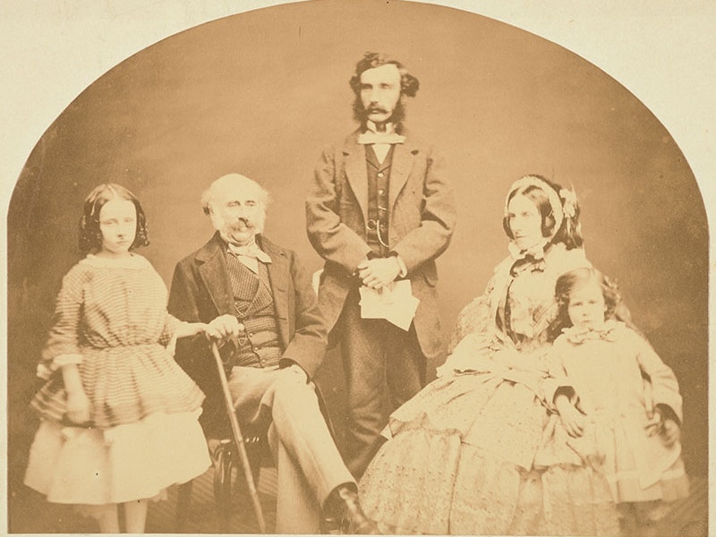 His Excellency Colonel Gore Browne & Family, photographer unknown, about 1860, carte-de-viste. Te Papa (O.013133) Family portrait. A man stands in the centre. He is flanked by an older man and an older woman, both sitting. They are flanked by two children