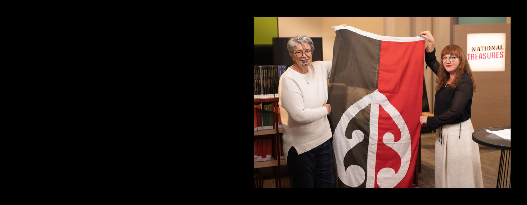 Two women holding up a flag