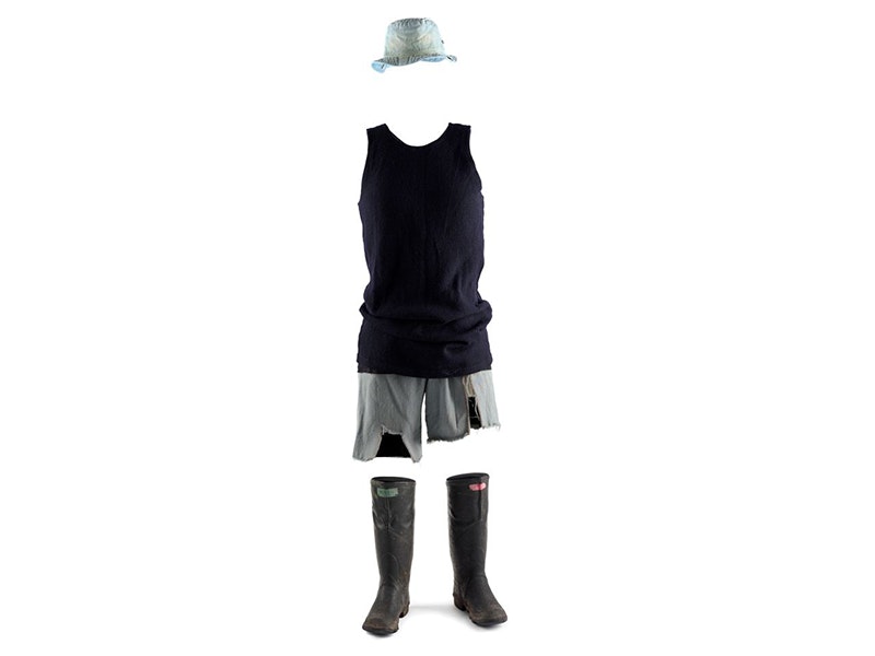Fred Dagg's singlet, manufactured by Mosgiel Woollen Factory Company (Limited), 1973. Gift of John Clarke, 2002. Te Papa (GH014302) Gumboots, shorts, a singlet and a hat set up like there is a person wearing them on a white background