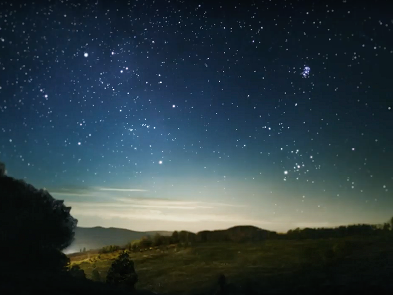 Still from Taikura Kapa Haka 2021 video series. Te Papa A starry sky over a darkened landscape