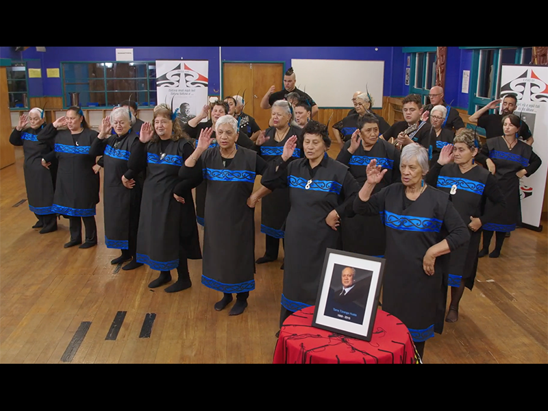 Video still from Taikura Kapa Haka 2021. Te Papa A group of people in a large room dancing with actions