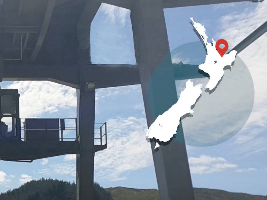 Video still from Saving longfin eels, Bay of Plenty. Te Papa A steel structure with blue sky behind and a map of New Zealand overlaid on the right-hand corner
