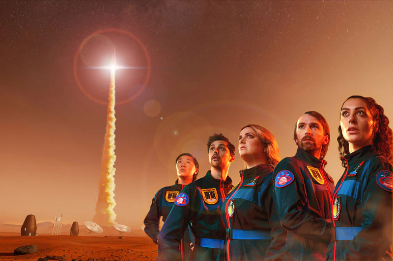 A group of astronauts look to the skies as a rocket takes off. The sky and ground are red, suggesting they are on Mars