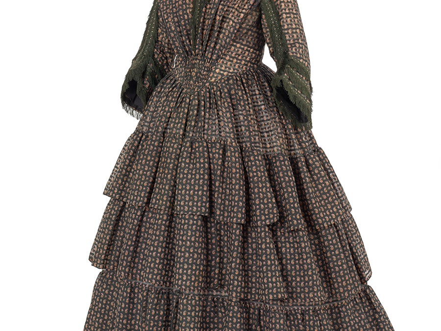 Afternoon dress, about 1850, maker unknown. Gift of Mrs P Cousins, 1965. CC BY-NC-ND 4.0. Te Papa (PC001060) A dark red 1850s dress on a mannequin with a white background