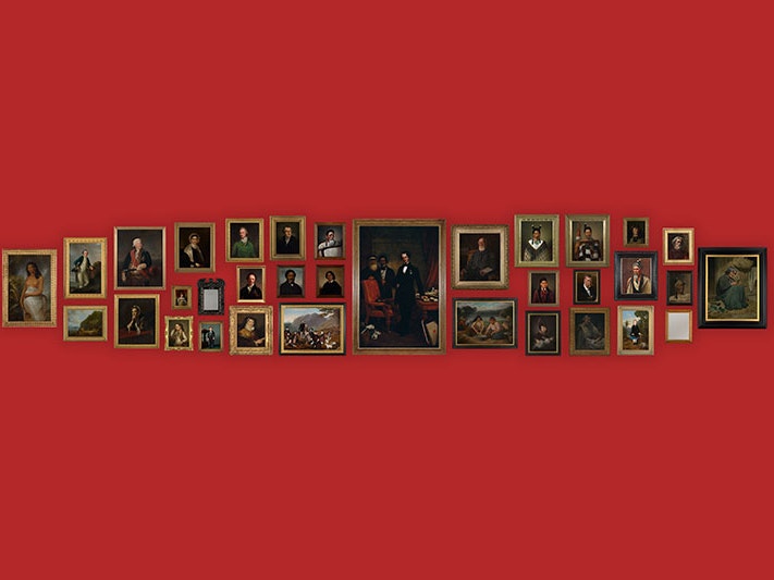 Ngā Tai Whakarongorua | Encounters, 2018. Te Papa A selection of portraits lined up on a red wall