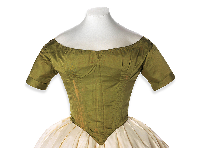 A green silk bodice on a mountmaker's dummy