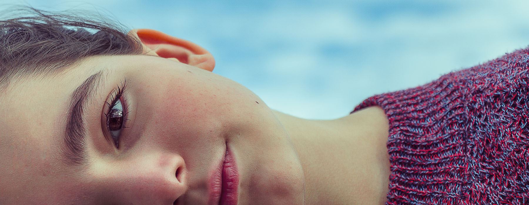 Close up of a young woman’s face, horizontally, cropped so you can only see half of it