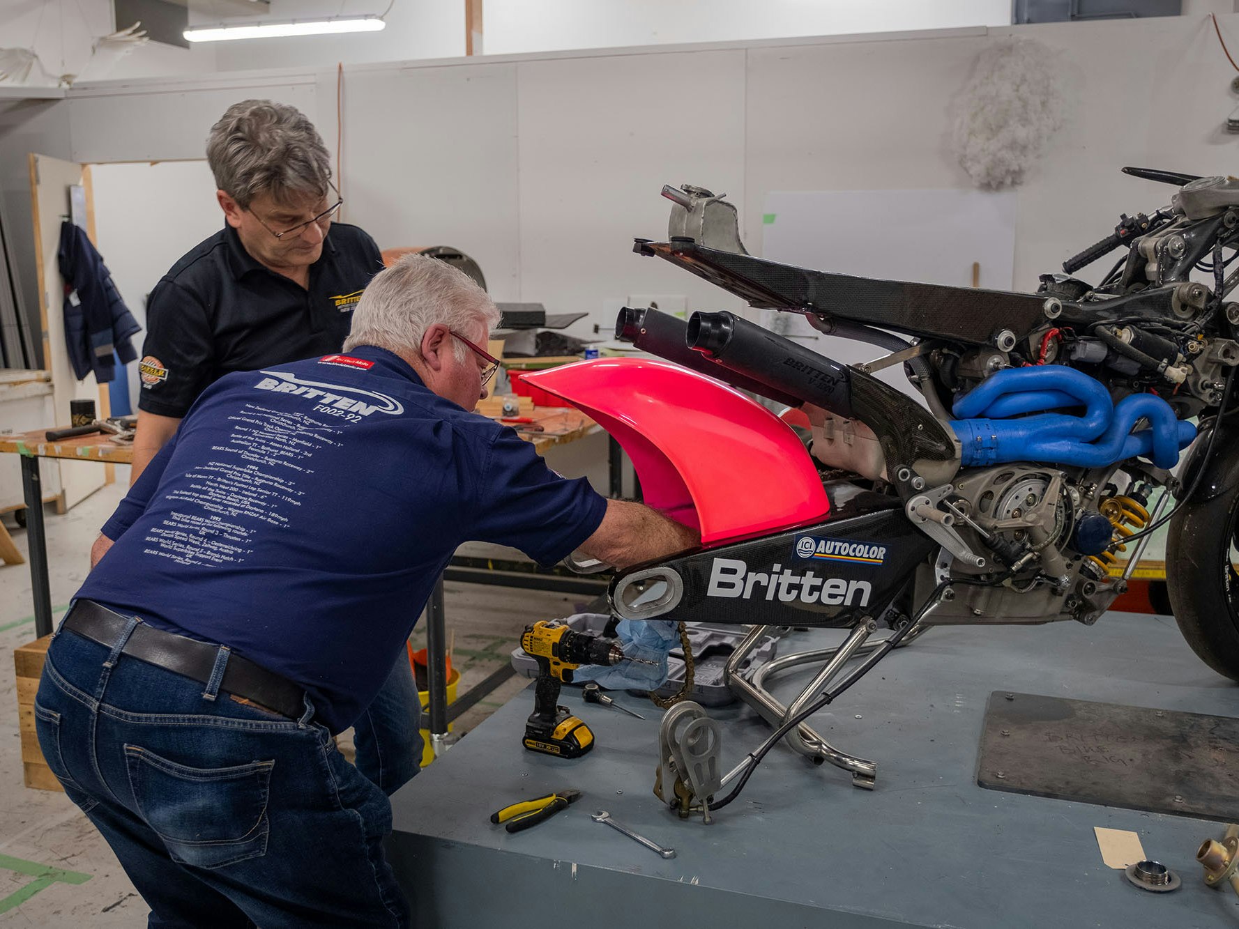 Britten team members Craig Roberts and Bob Brookland work to remove the rear mudguard from the Britten V1000, having taken off the rear wheel Bob and Craig remove the rear mudguard from the Britten Bike