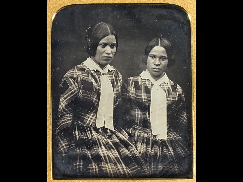 Caroline and Sarah Barrett, circa 1852-3, Lawson Insley, collection of Puke Ariki a black and white photo of two girls. The photo has a gold frame.