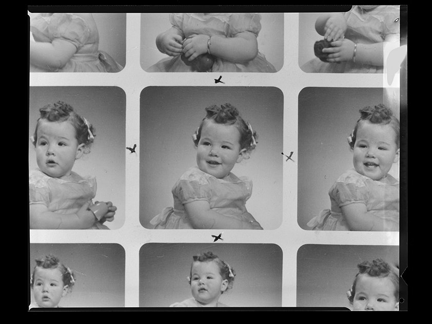 Child, inscribed: 'Mrs. Zino', Spencer Digby Studios, 1960. Spencer Digby / Ronald D Woolf Collection. Gift of Ronald Woolf, 1975. Te Papa (B.080696) A photographic contact sheet with 9 images of a child and x marks near some of them