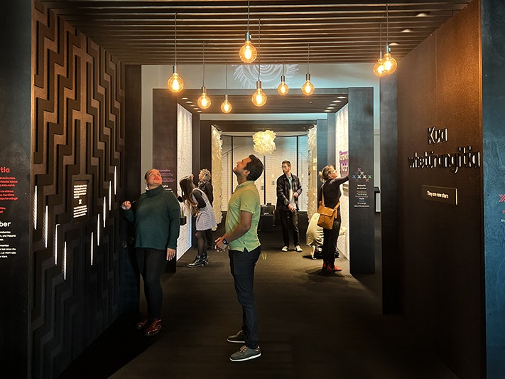 Mānawatia a Matariki exhibition at Te Papa. Photo by Tia Nepia Su‘a. Te Papa (228855) Several people standing an looking at lighting and parts of a wall in an archway inside a building