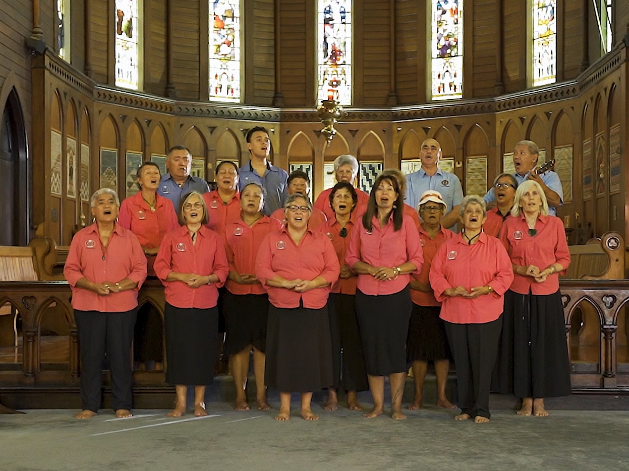 Still from Auckland Anglican Māori Club Taikura Kapa Haka 2022 series A group of people singing on a church altar