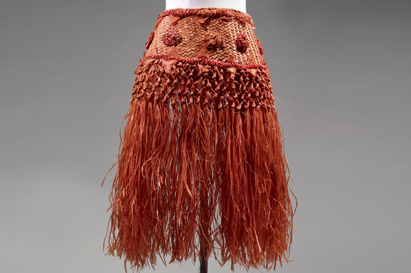 A burnt orange woven skirt on a model dummy