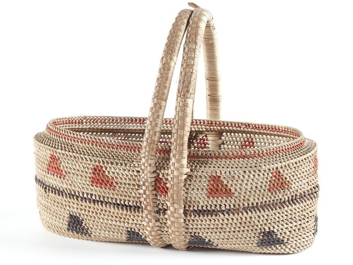 Kato (basket), Niue, about 1920s, pandanus fibre, artist unknown. Purchased 1931 (Te Papa FE007907) A woven basket sitting on a white background