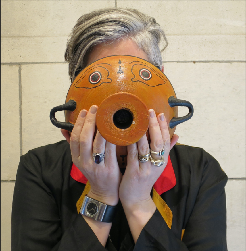 A woman holding a bowl up to her face