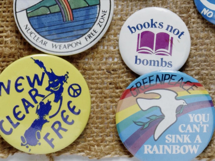 Still from Tiny Activism, 2019. Te Papa Close up of badges with anti-nuclear messages on them