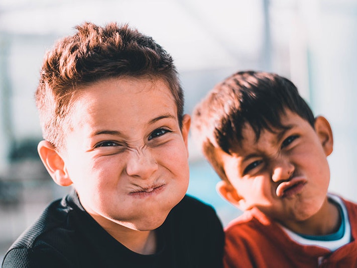 Photo by Austin Pacheco / Unsplash Two young boys scrunch up their faces at the camera