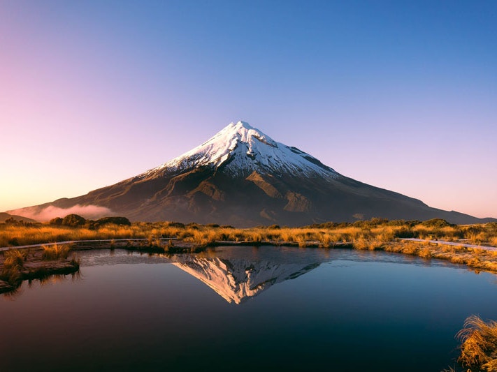 Taranaki maunga, 2020. Photo by Sophie Turner. Te Papa View of conical Mt Taranaki, with a body of water in front of it reflecting the mountain