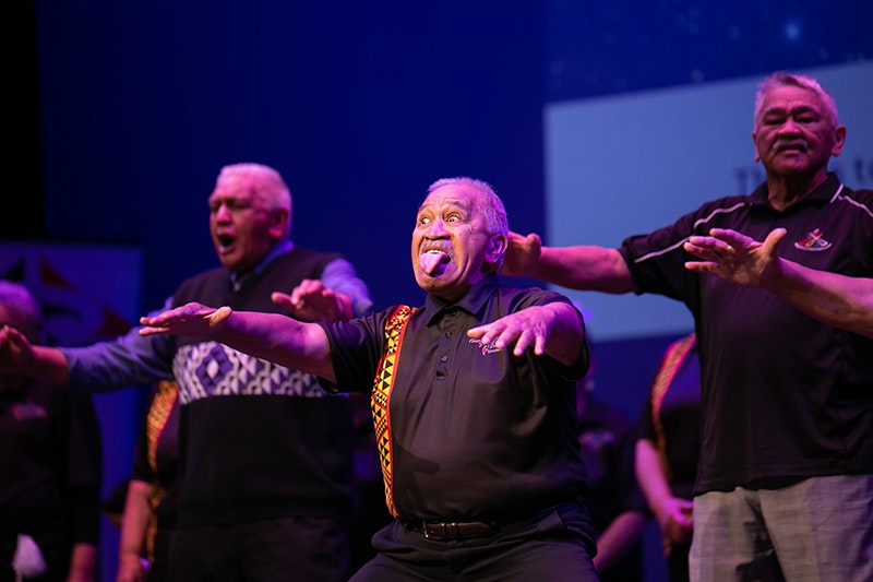 three men performing on stage