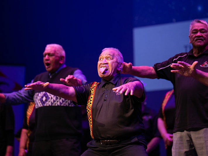 taikura_kapa_haka-495-_med_res_for_prints_up_to_a4_hd_screen_presentation_and_general_use_-_jpg.jpg three men performing on stage